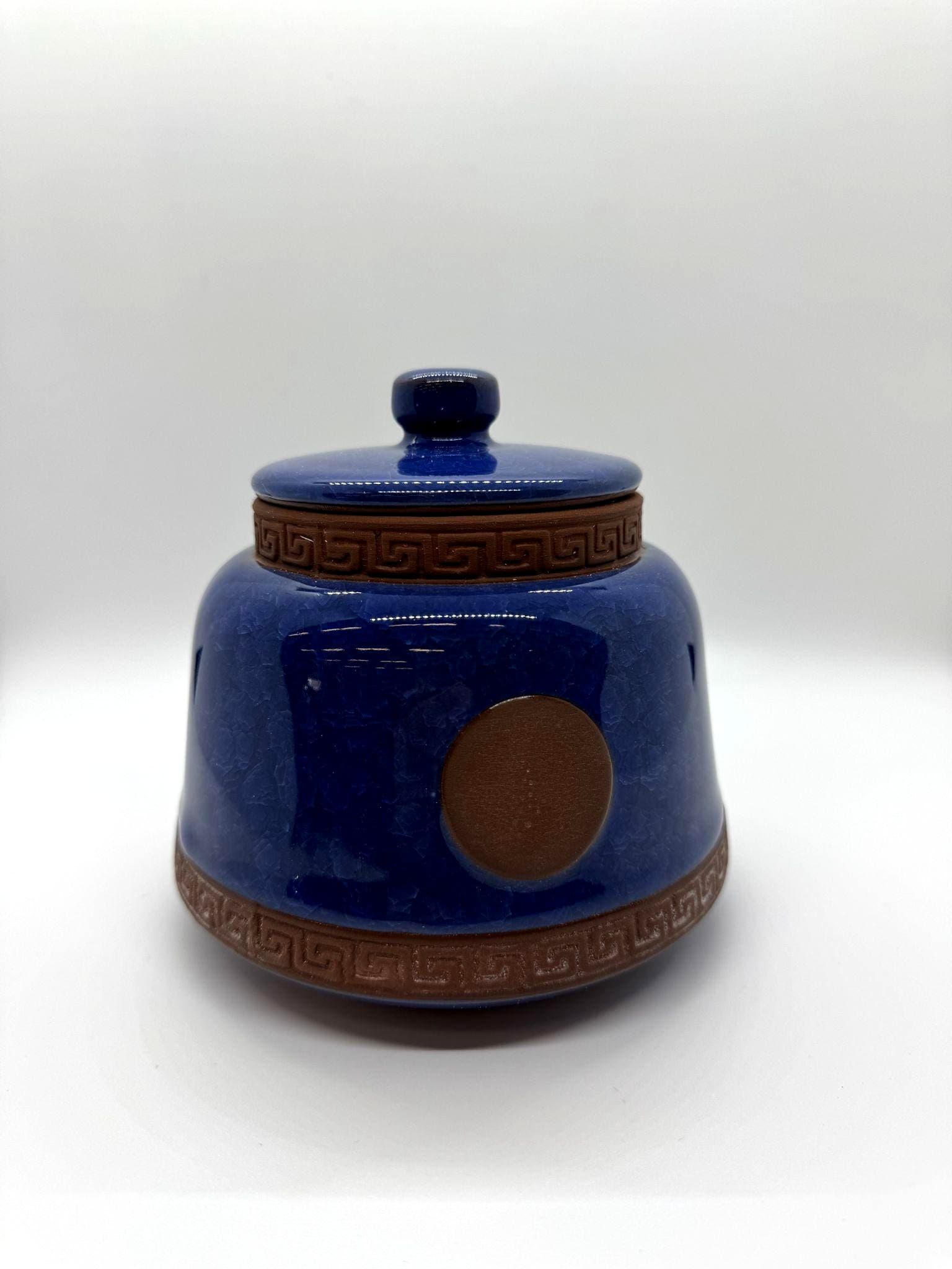 Handcrafted cobalt blue ceramic urn with a warm, artisan feel.