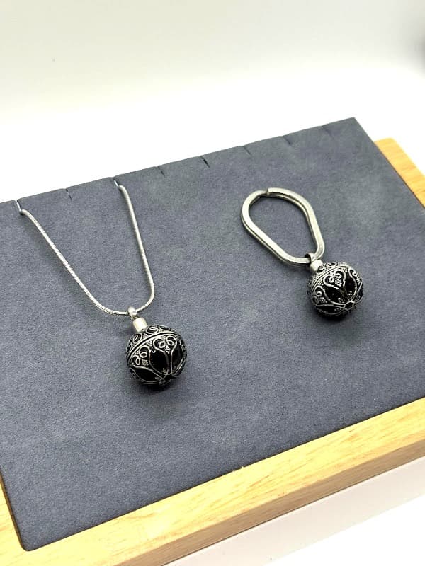 Antique-style silver sphere, usable as keychain or pendant.