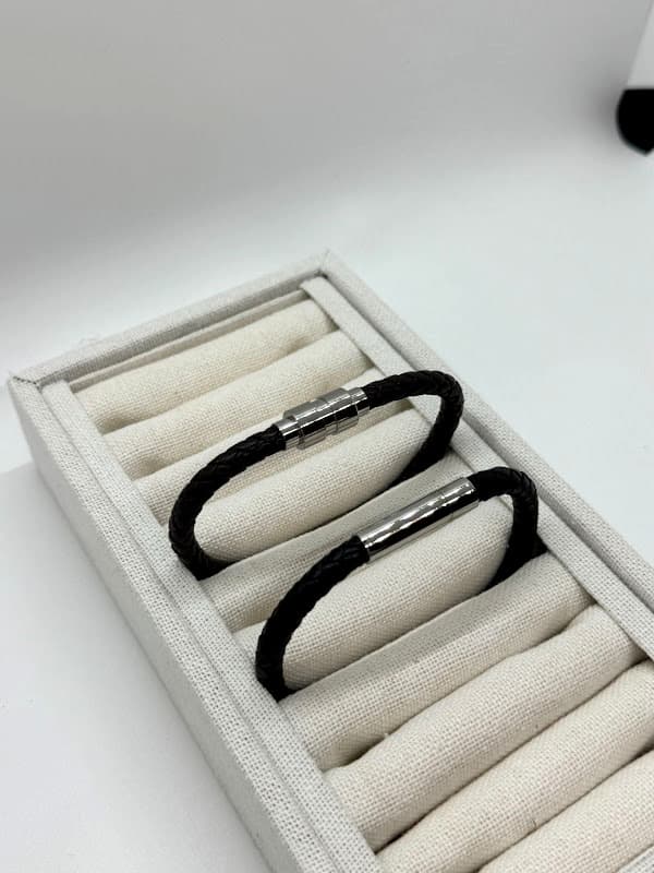 Braided leather bracelet with magnetic closure. Available in brown and black.
