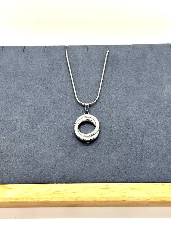 Silver pendant with entwined circles design.