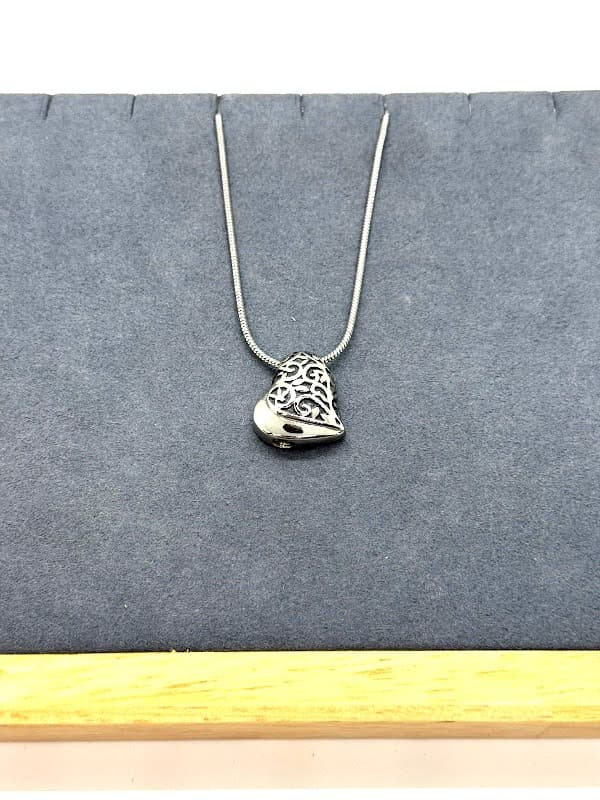 Silver filigree heart necklace.