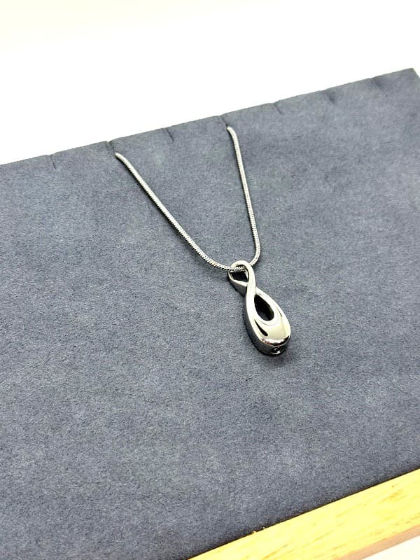Silver infinity symbol necklace.