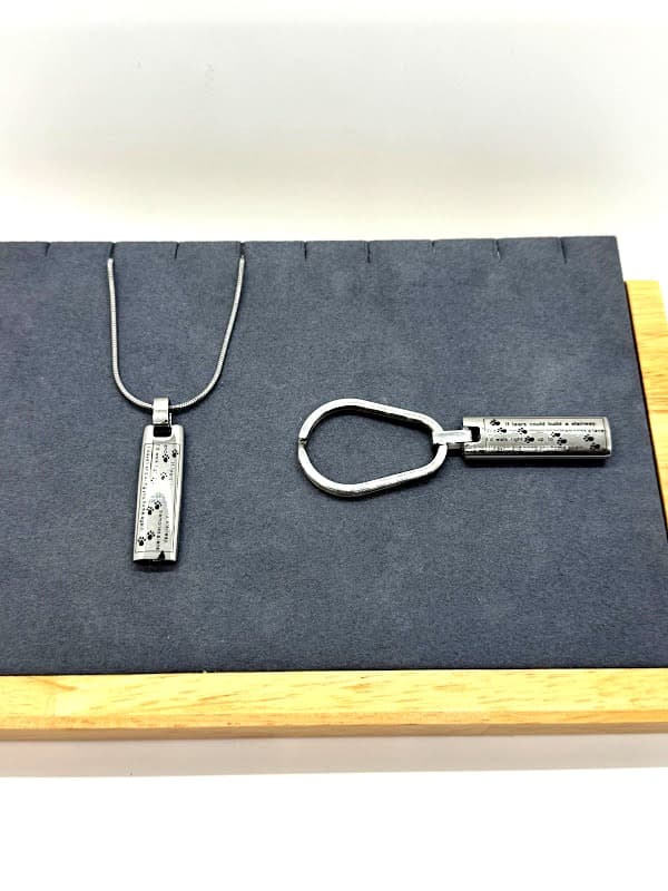 Silver keychain/pendant inscribed with memorial poem.