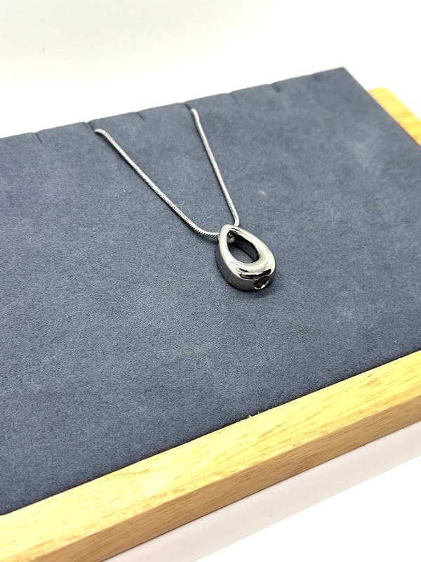 Silver teardrop-shaped pendant.