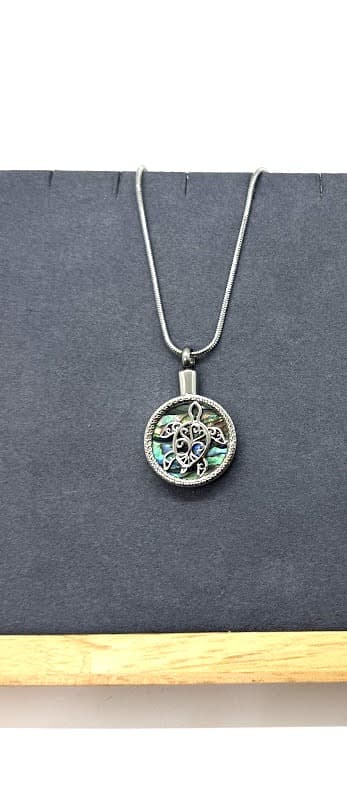 Turtle pendant with abalone shell detail.