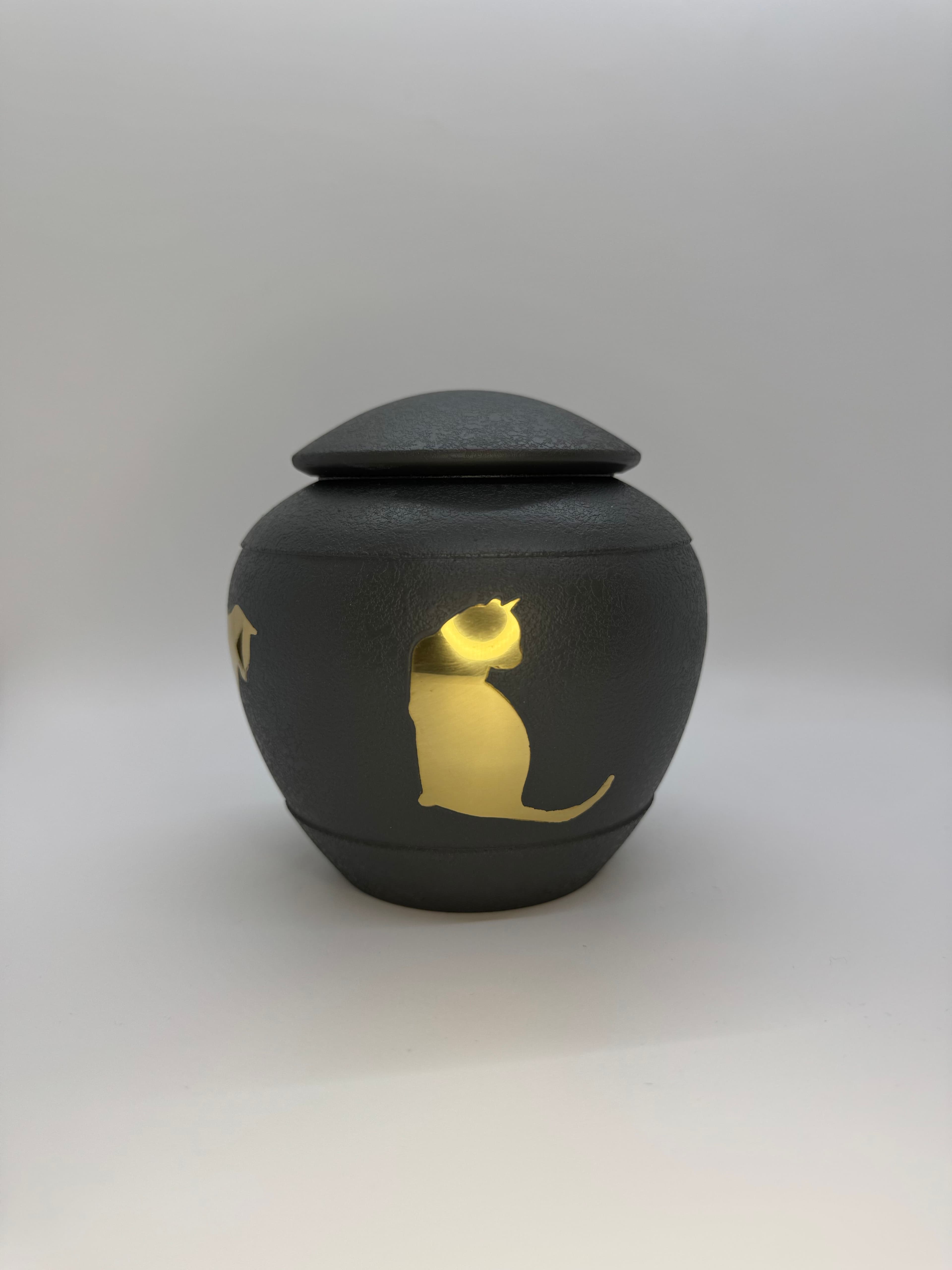Cool grey metal urn featuring golden cat silhouettes around the urn.
