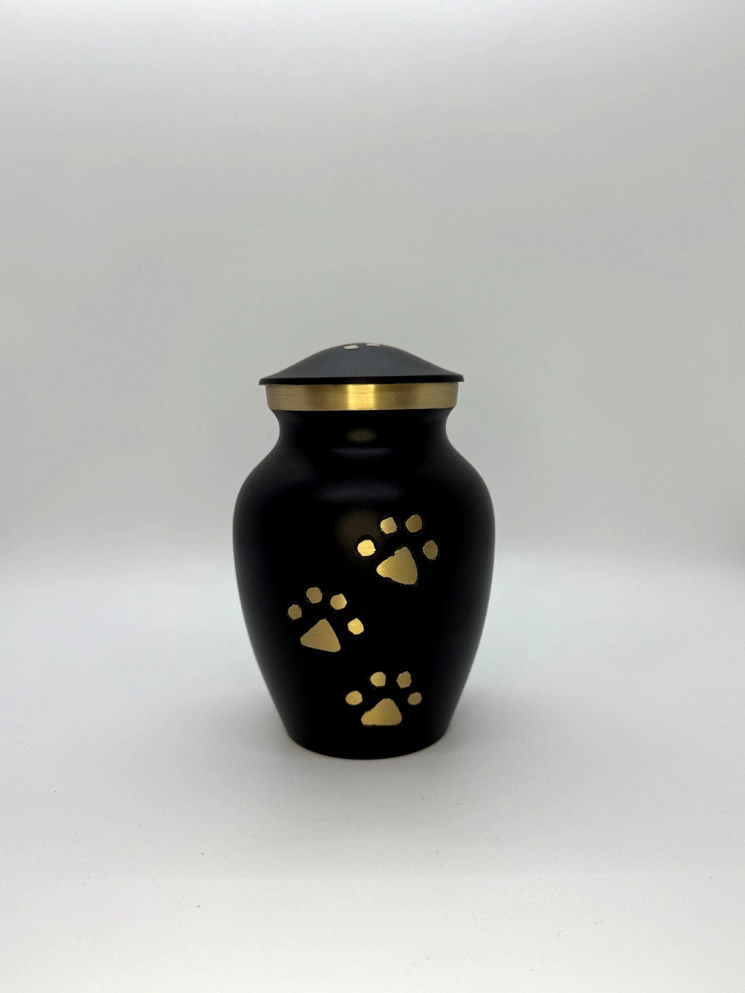 Matte black urn with gold paw print accents from the Paws to Heaven collection.