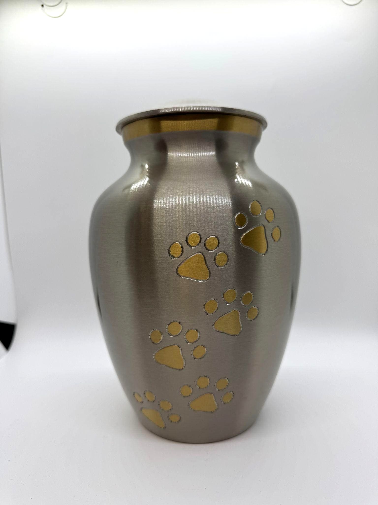 Pewter-finish urn with gold paw print accents from the Paws to Heaven collection.