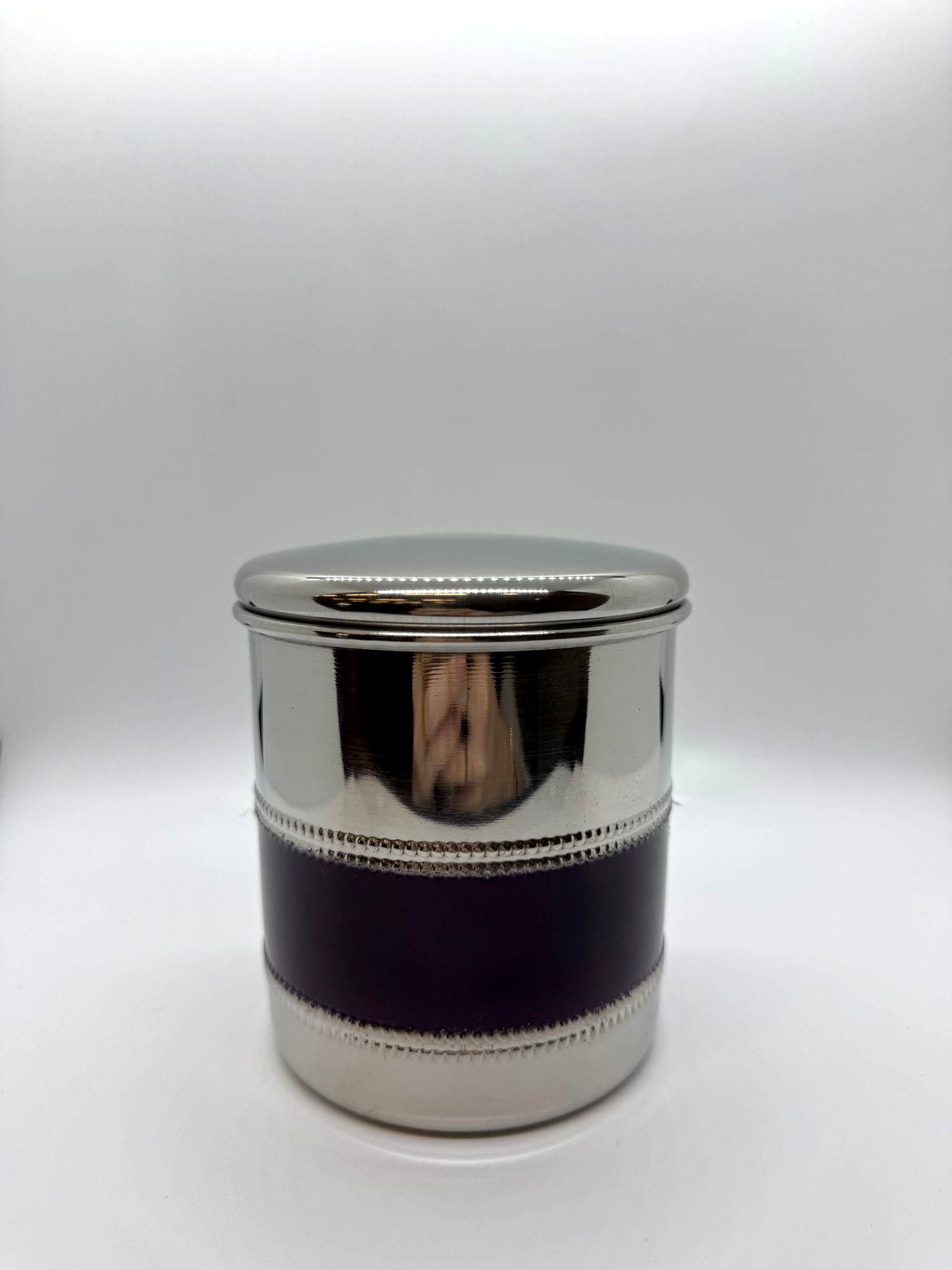 Silver canister urn with plum-colored decorative band.