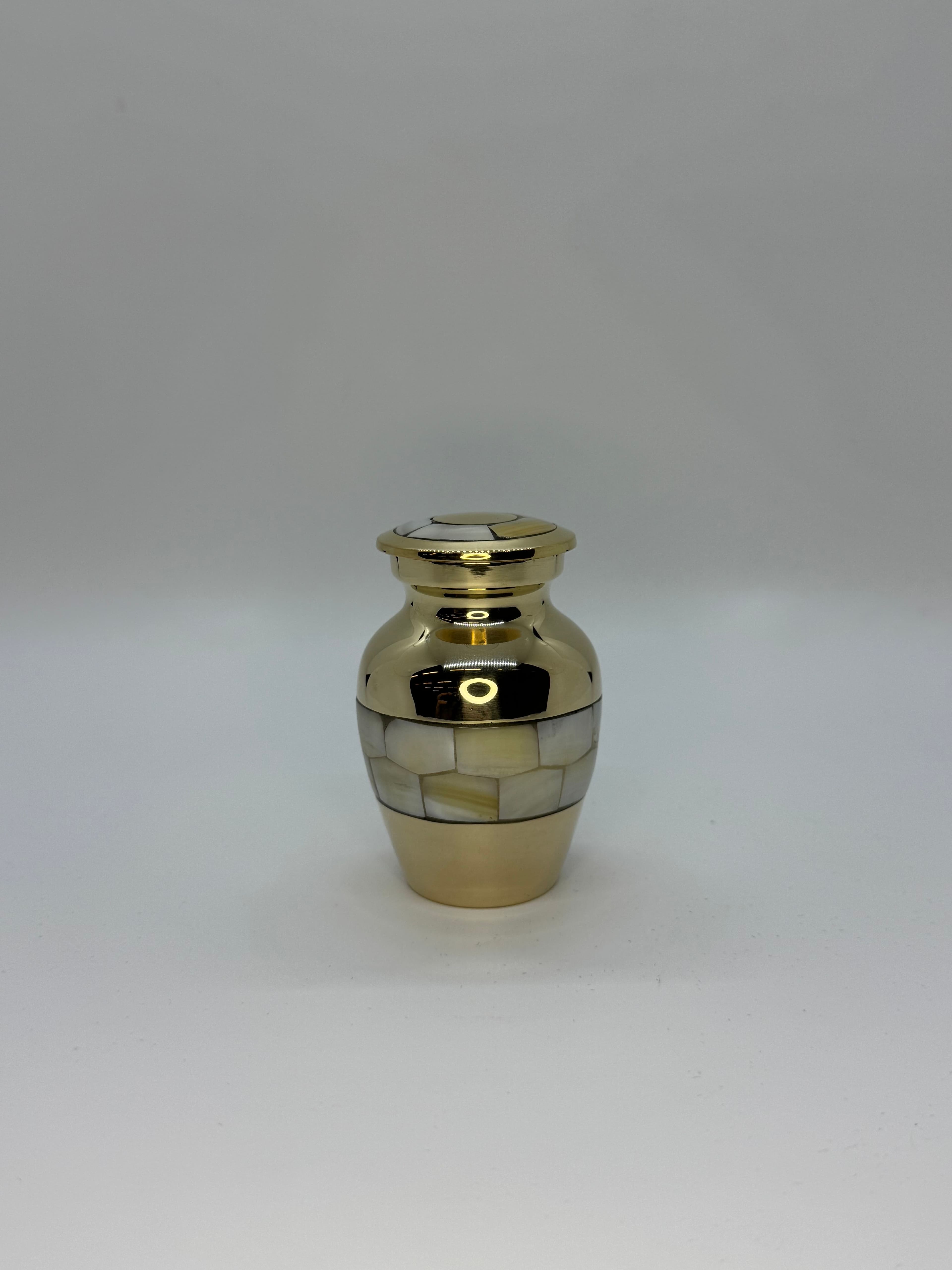 Gold color keepsake size urn with Mother of Pearl embellishments.