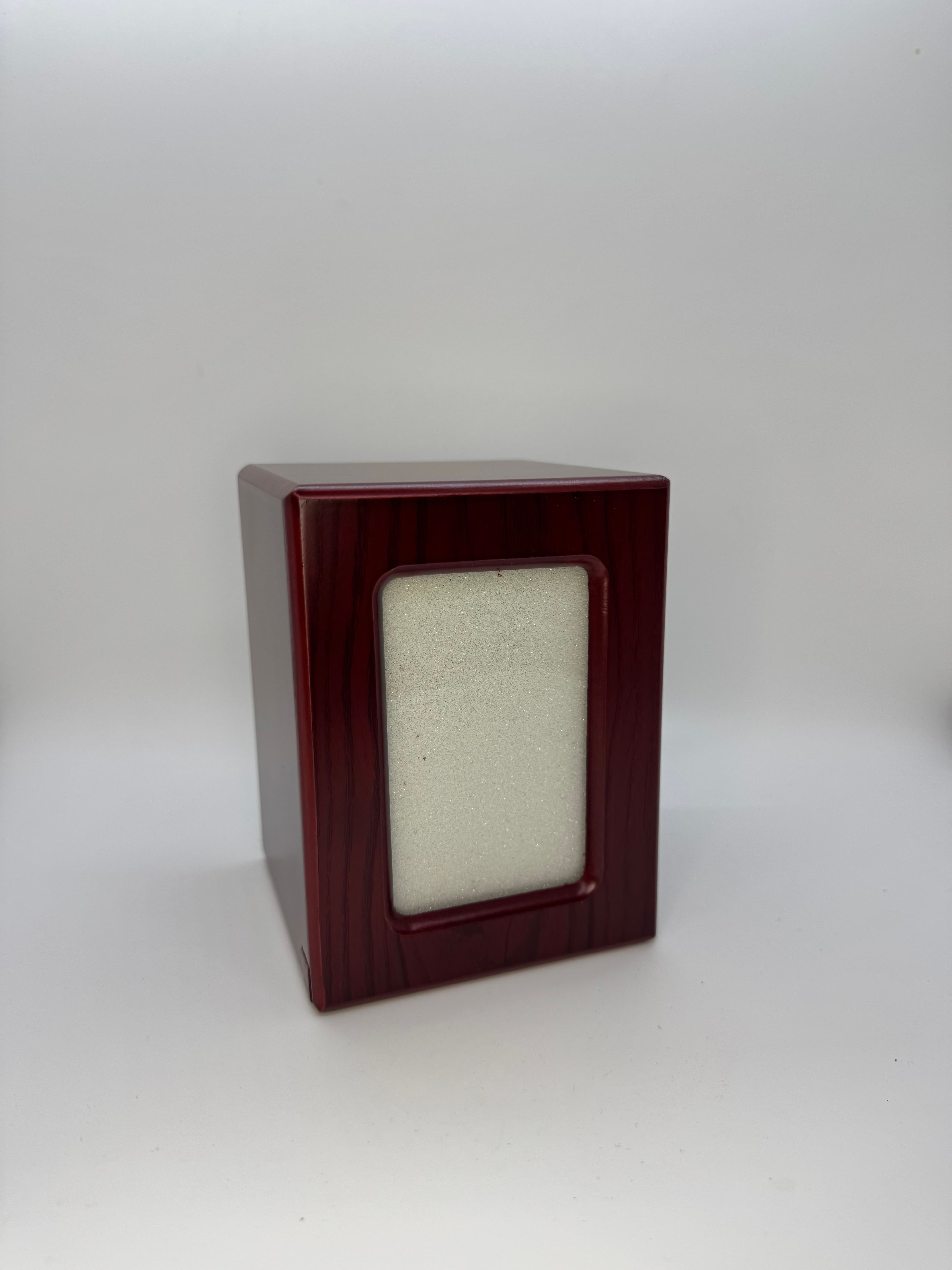 A cherry-finish photo urn with a framed window for your favorite picture.