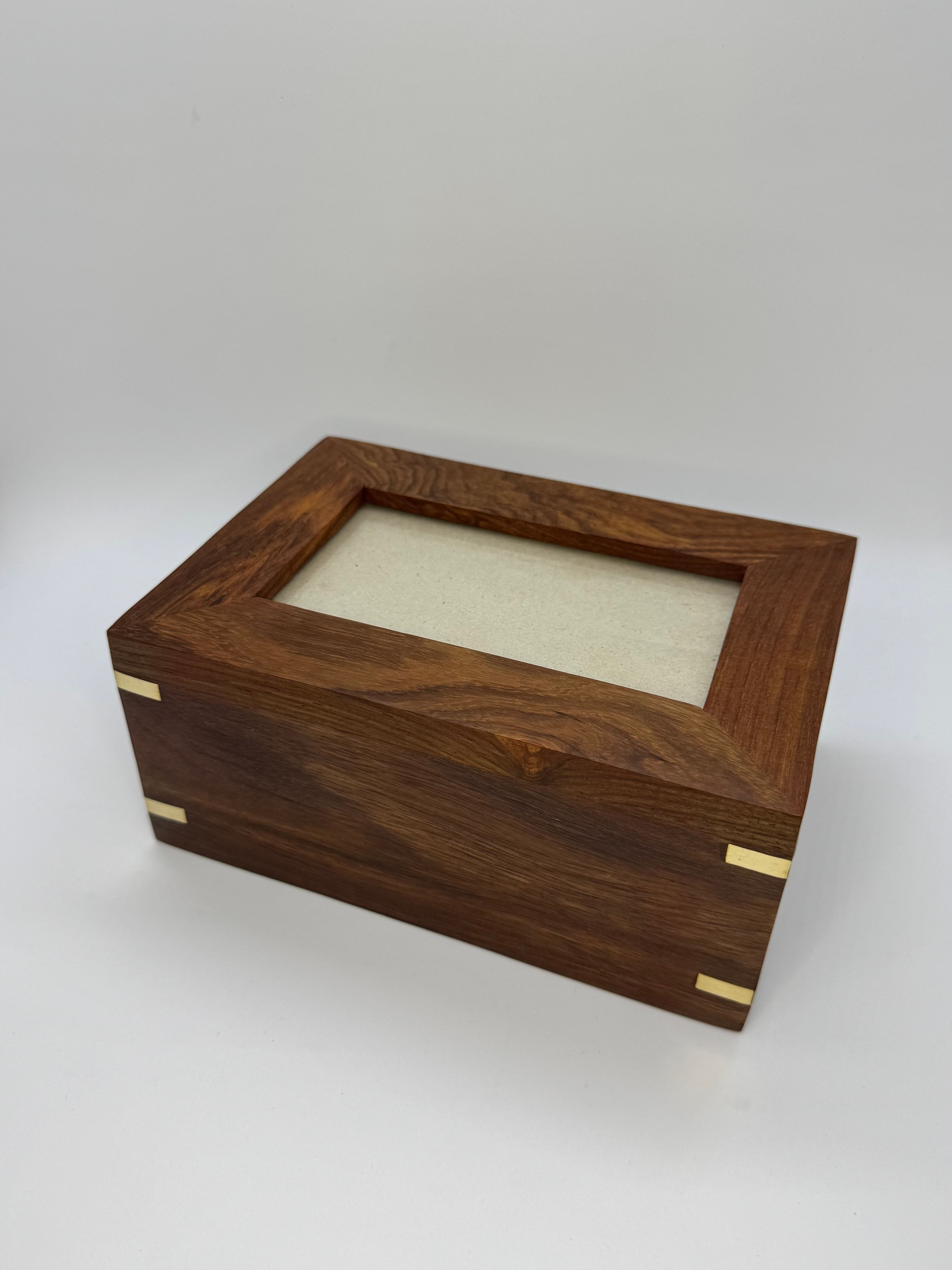 Urn with brass corners and a photo frame window.