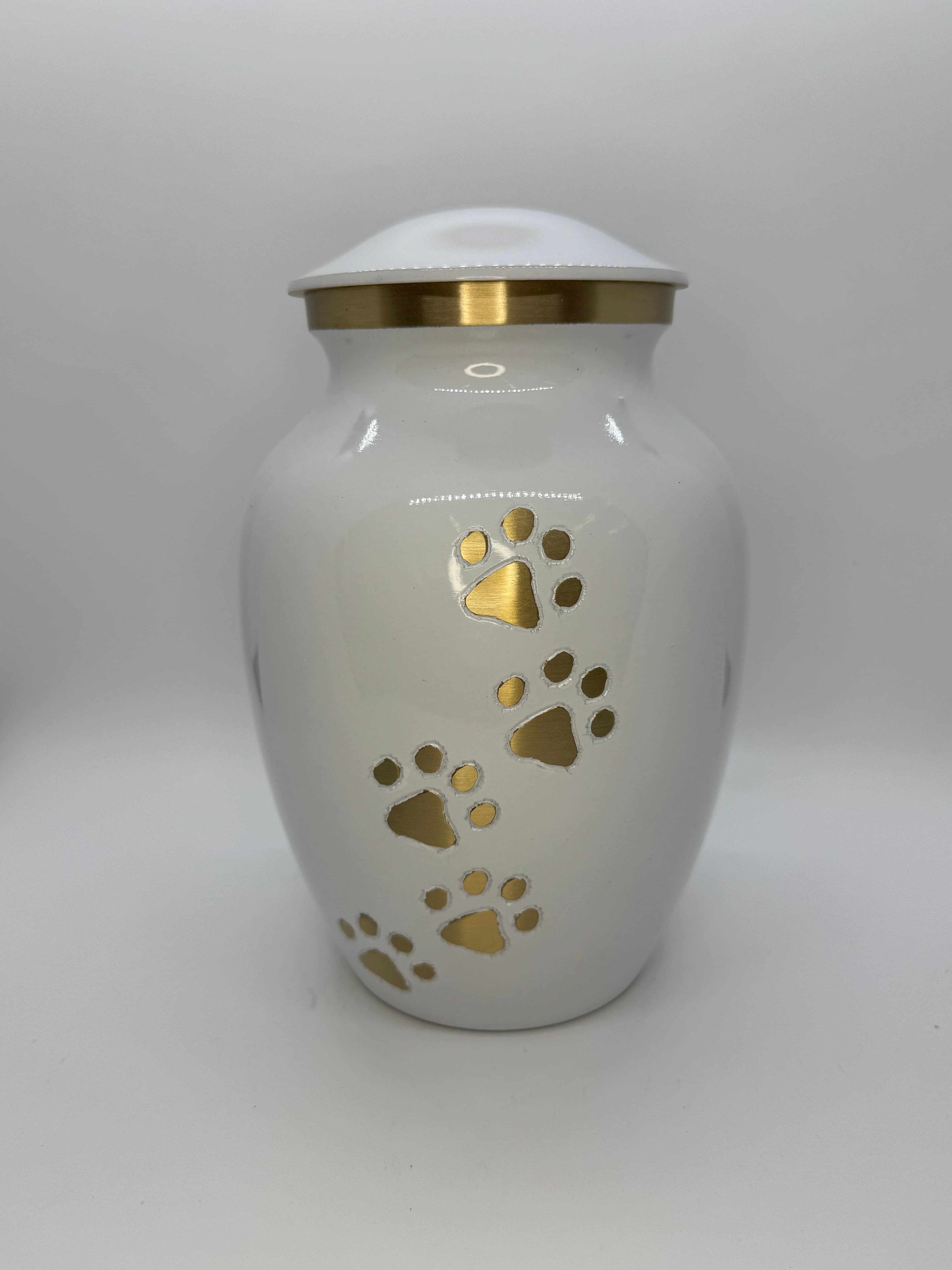 White metal urn with gold paw print accents from the Paws to Heaven collection.
