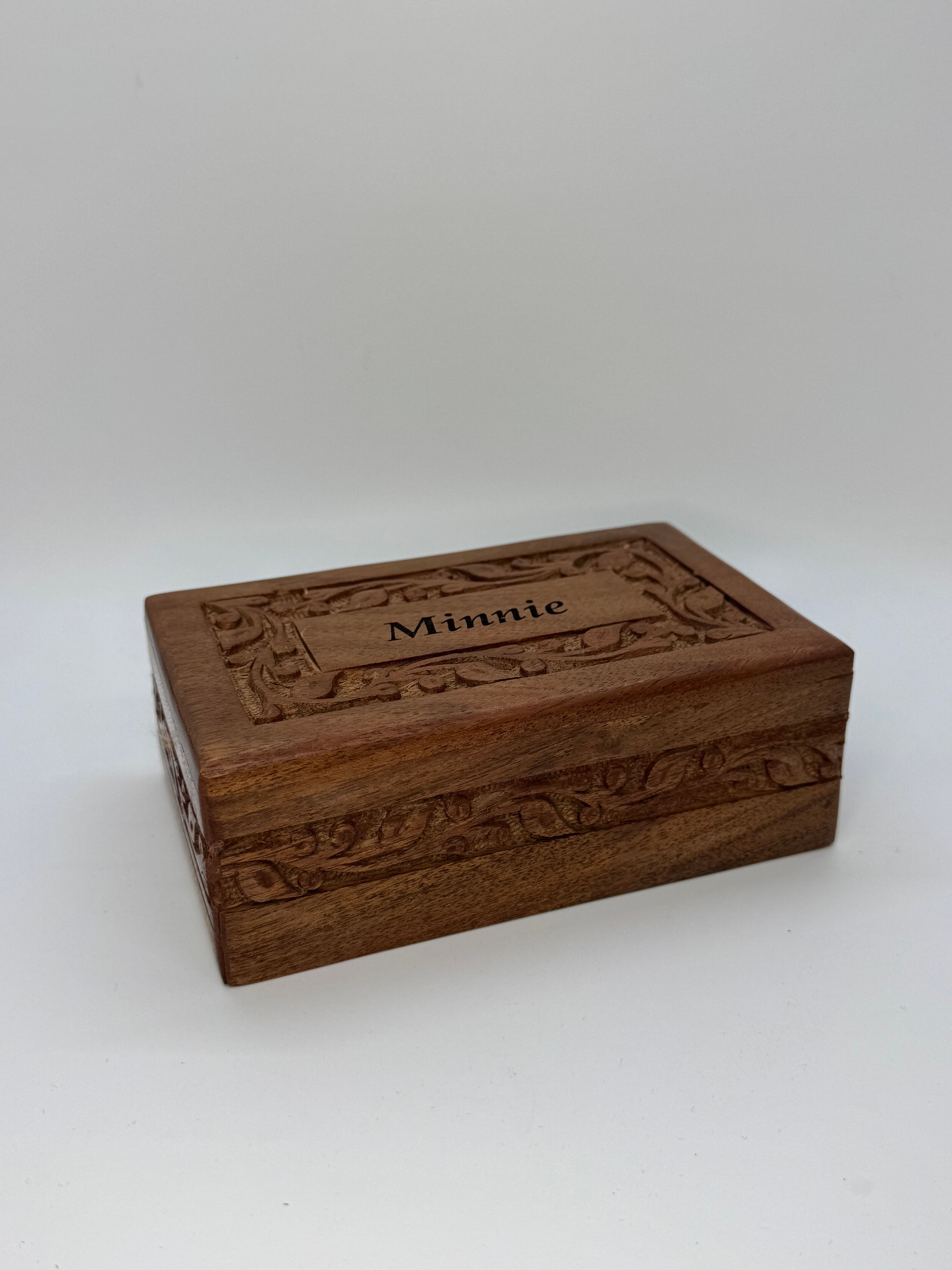 Rosewood urn with carved ivy pattern.