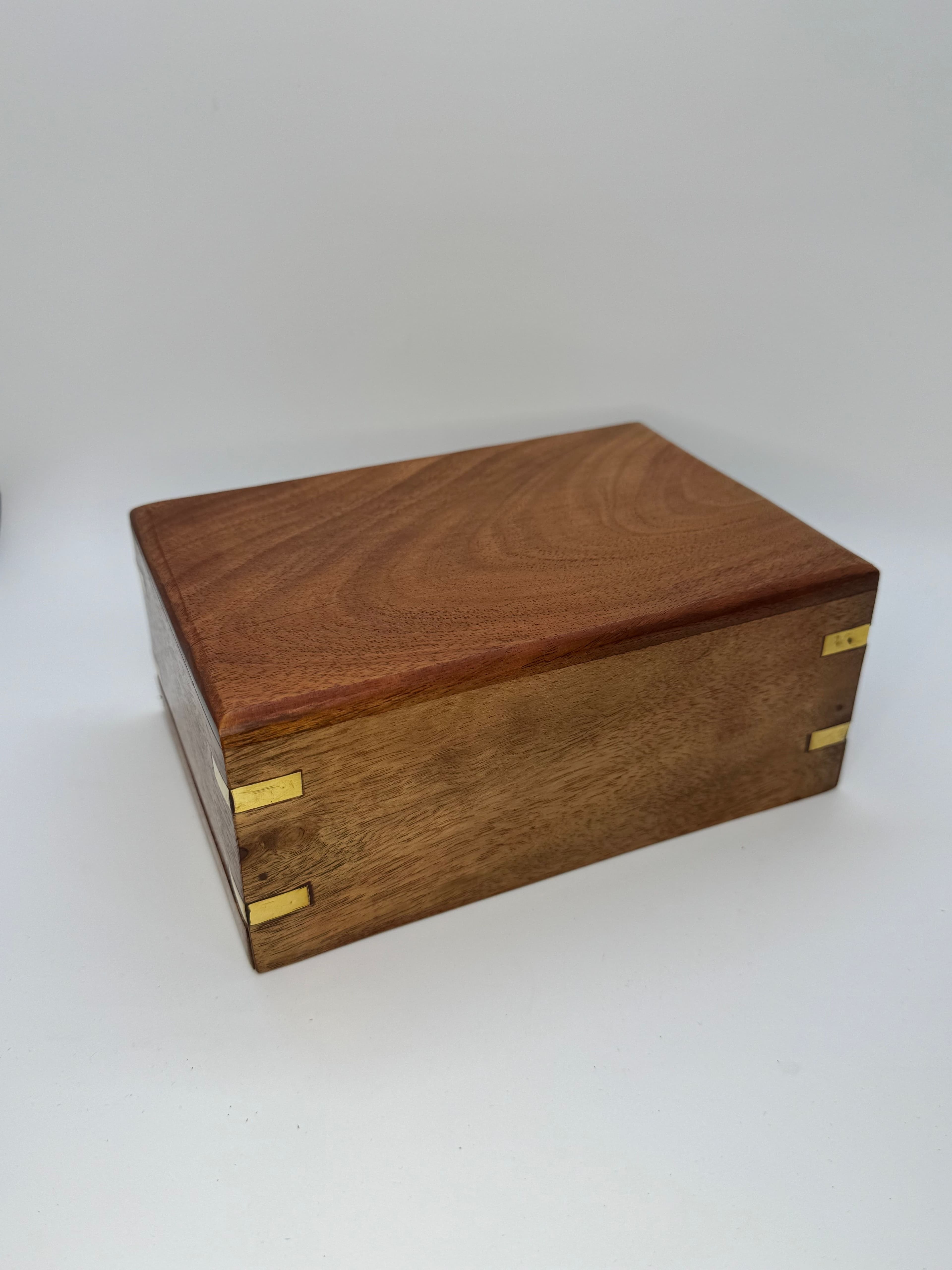 Rosewood urn with brass corner accents.